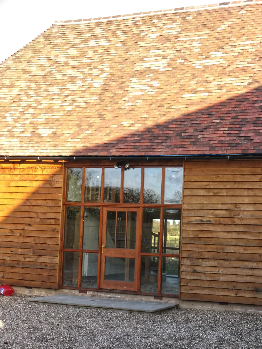 Timber clad barn conversion with tall glazed doors