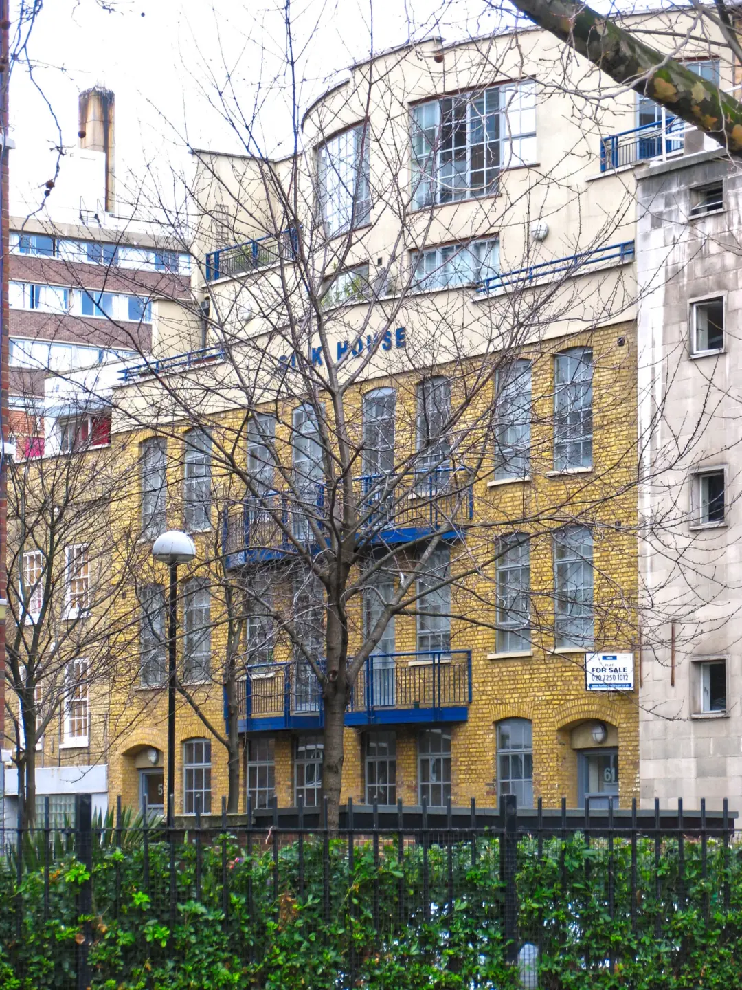 Yellow brick apartment and office building with balconies