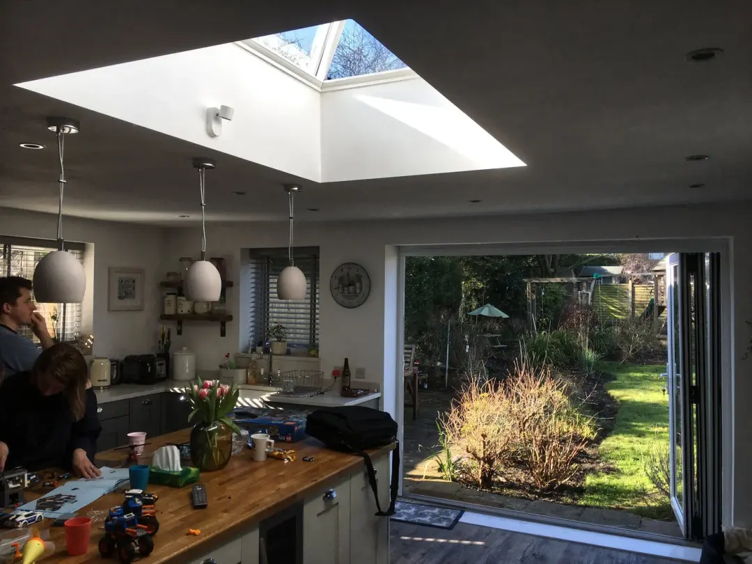 Kitchen extension with a roof lantern and doors open to the garden