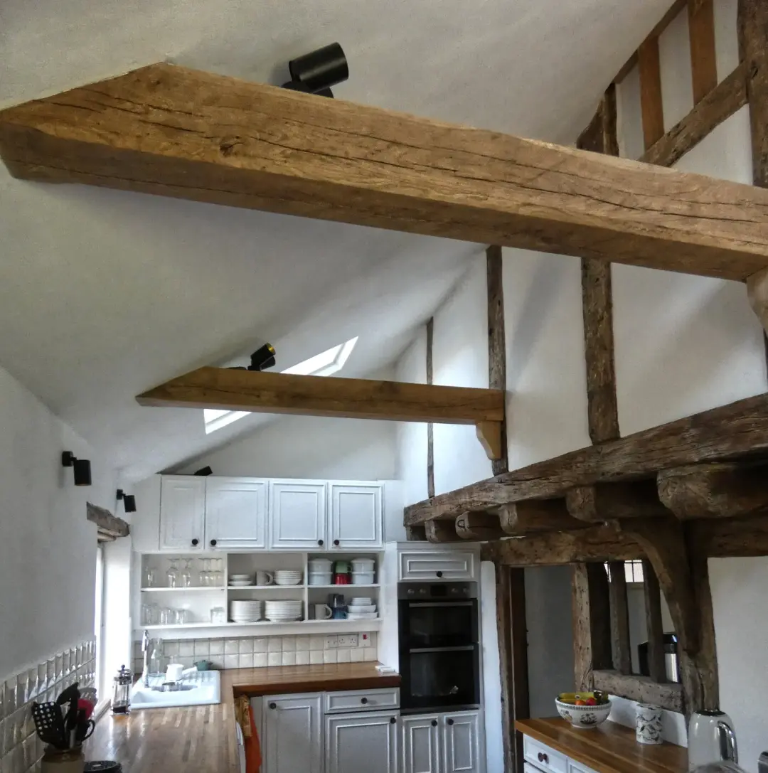 Renovated kitchen beneath exposed oak beams