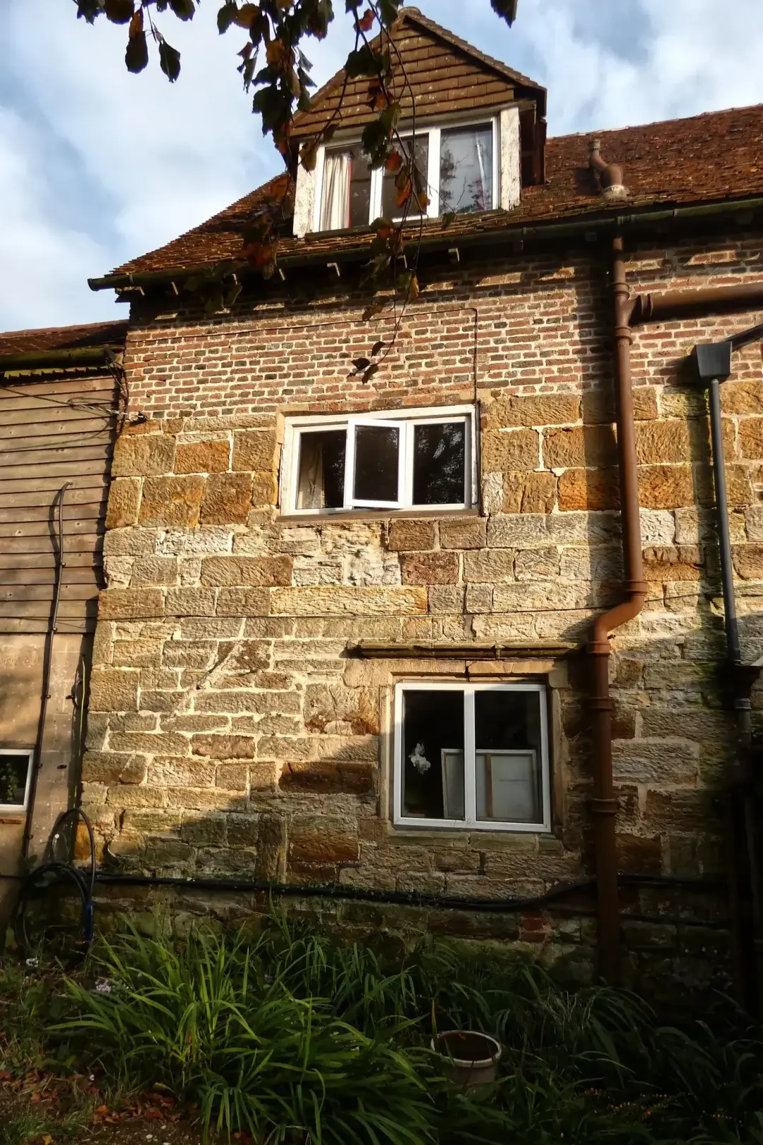 Sandstone period house with small paned windows