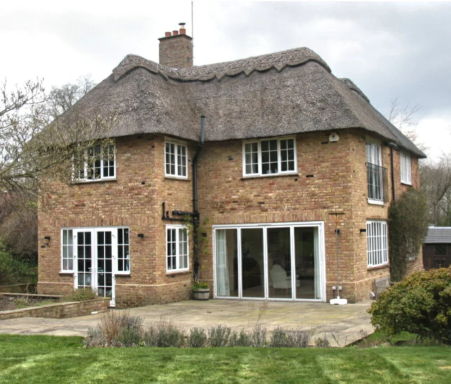 Thatched brick house with garden doors
