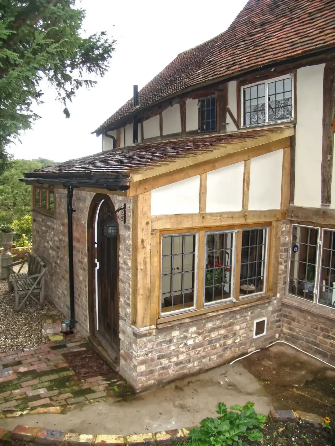 Timber framed house with a stone and oak oriel window