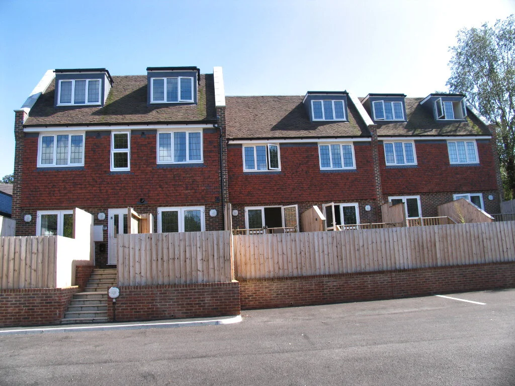 Terrace of new three storey townhouses with dormer windows