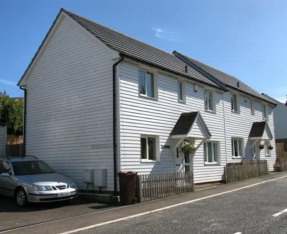 New weatherboarded houses along a residential street